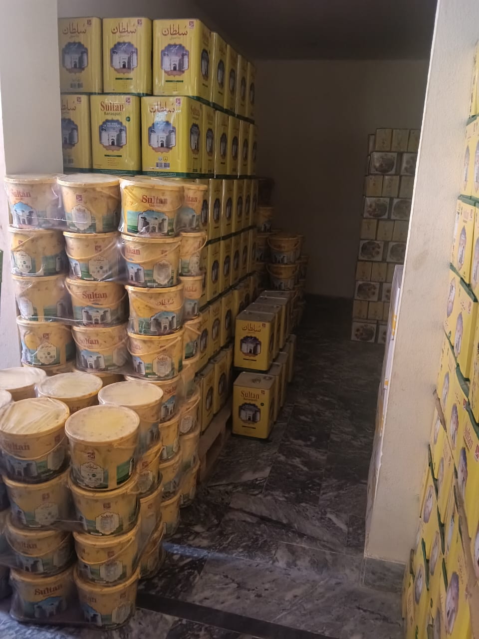Stacked Sultan Banaspati cartons across warehouse floor